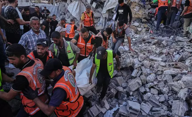 Palestinian civil defense crews carry a body from the rubble of a collapsed building that housed displaced Palestinians and was heavily damaged during the Israel-Hamas war, in Gaza City, Wednesday, Sept. 16, 2026. (AP Photo/Jehad Alshrafi)