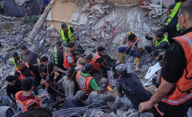 Palestinian civil defense crews search for bodies and survivors in the rubble of a collapsed building that housed displaced Palestinians and was heavily damaged during the Israel-Hamas war, in Gaza City, Wednesday, Sept. 16, 2026. (AP Photo/Jehad Alshrafi)