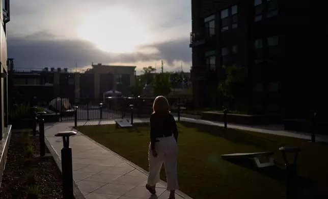 Debra Fox, who had $58,000 stolen from her in a romance scam, goes for a walk outside her apartment complex, Wednesday, May 13, 2026, in Arvada, Colo. (AP Photo/David Goldman)