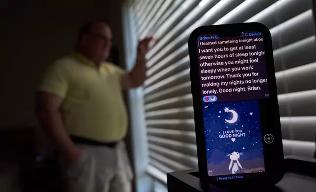 A text message from a scammer who stole $575,000 from Brian Glick is displayed on Glick's phone as he poses for a portrait at his home, Wednesday, June 25, 2025, in Ballston Lake, N.Y. (AP Photo/David Goldman)