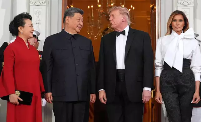 President Donald Trump and first lady Melania Trump greet China's President Xi Jinping and his wife Peng Liyuan as they arrive at the North Portico of the White House for a State Dinner, Thursday, Sept. 24, 2026, in Washington. (AP Photo/Alex Brandon)