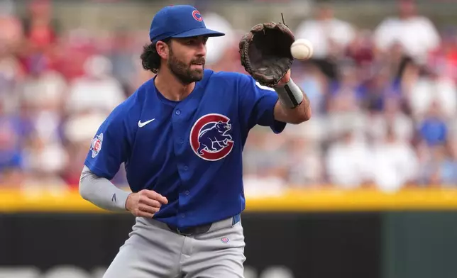 Chicago Cubs shortstop Dansby Swanson fields a ground ball during the first inning of a baseball game against the Cincinnati Reds, Saturday, Sept. 19, 2026, in Cincinnati. (AP Photo/Kareem Elgazzar)