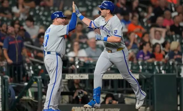 Kansas City Royals' Vinnie Pasquantino (9) celebrates with third base coach Vance Wilson (17) after hitting a home run during the sixth inning of a baseball game against the Houston Astros in Houston, Tuesday, Sept. 15, 2026. (AP Photo/Ashley Landis)