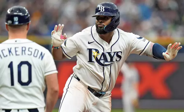 Tampa Bay Rays' Junior Caminero, right, celebrates after his single off Boston Red Sox pitcher Garrett Whitlock during the ninth inning of a baseball game Saturday, Sept. 19, 2026, in St. Petersburg, Fla. (AP Photo/Chris O'Meara)