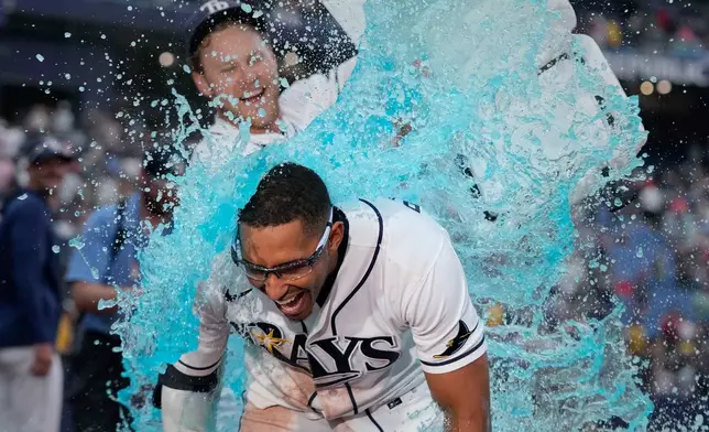 Tampa Bay Rays' Richie Palacios, front, gets doused by Taylor Walls after Palacios hit a walk off single off Boston Red Sox pitcher Garrett Whitlock during the ninth inning of a baseball game Saturday, Sept. 19, 2026, in St. Petersburg, Fla. (AP Photo/Chris O'Meara)