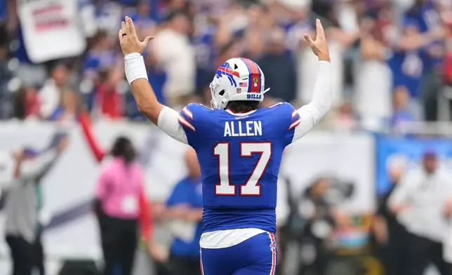 Buffalo Bills quarterback Josh Allen (17) reacts after wide receiver DJ Moore scored a touchdown during the first half of an NFL football game against the Houston Texans, Sunday, Sept. 13, 2026, in Houston. (AP Photo/Ashley Landis)