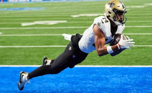 New Orleans Saints wide receiver Devaughn Vele (14) pulls in a touchdown reception against the Detroit Lions in the second half of an NFL football game, Sunday, Sept. 13, 2026, in Detroit. (AP Photo/Paul Sancya)