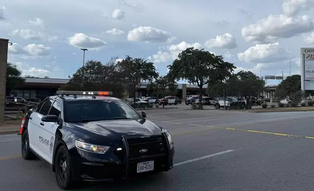 In this photo taken with a smart phone Police block a street after a shooting involving an ICE officer in Austin, Texas, Sunday, Sept. 20, 2026. (AP Photo/Jesse Bedayn)