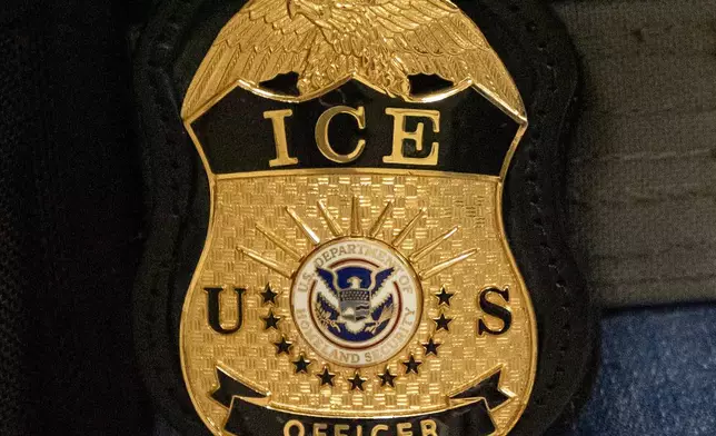 FILE - A federal agent wears an Immigration and Customs Enforcement badge in New York, June 10, 2025. (AP Photo/Yuki Iwamura, File)