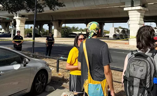 In this photo taken with a smart phone Police block a street after a shooting involving an ICE officer in Austin, Texas, Sunday, Sept. 20, 2026. (AP Photo/Jesse Bedayn)