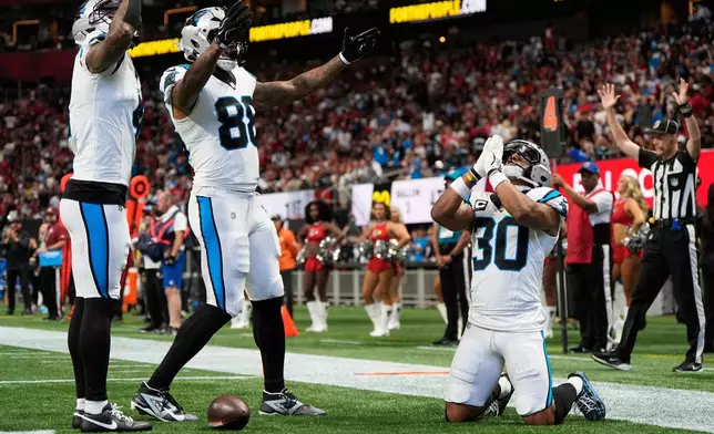 Carolina Panthers running back Chuba Hubbard (30) celebrates a touchdown during an NFL football game against the Atlanta Falcons in Atlanta, Sunday, Sept. 20, 2026. (AP Photo/Mike Stewart)