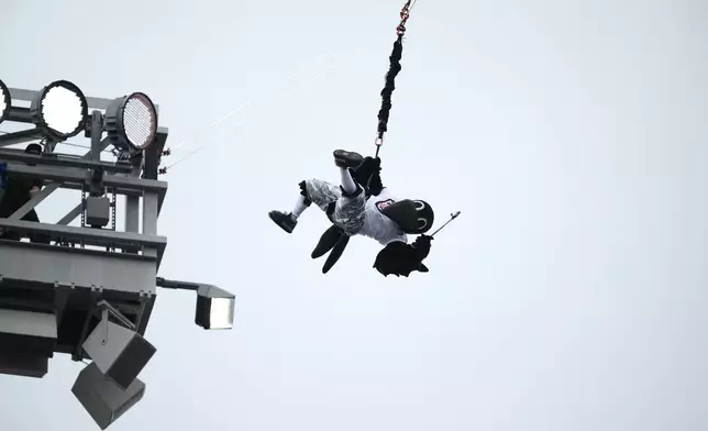 The Baltimore Ravens mascot "Poe" zip lines from a light tower before an NFL football game against the New Orleans Saints in Baltimore, Sunday, Sept. 20, 2026. (AP Photo/Nick Wass)