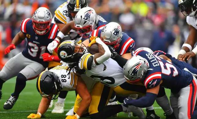 Pittsburgh Steelers' Rico Dowdle (13) drives past New England Patriots' Christian Elliss (53) during the first half of an NFL football game, Sunday, Sept. 20, 2026, in Foxboro, Mass. (AP Photo/Steven Senne)