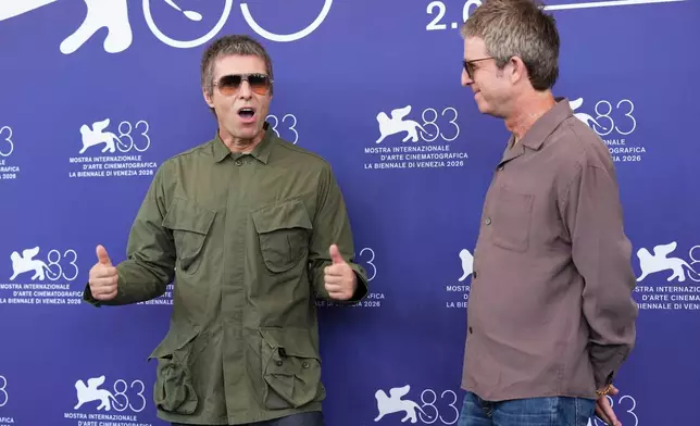 Liam Gallagher, left, and Noel Gallagher pose for photographers at the photo call for the film 'Oasis: Don't Look Back In Anger' during the 83rd edition of the Venice Film Festival in Venice, Italy, on Saturday, Sept. 5, 2026. (Photo by Scott A Garfitt/Invision/AP)
