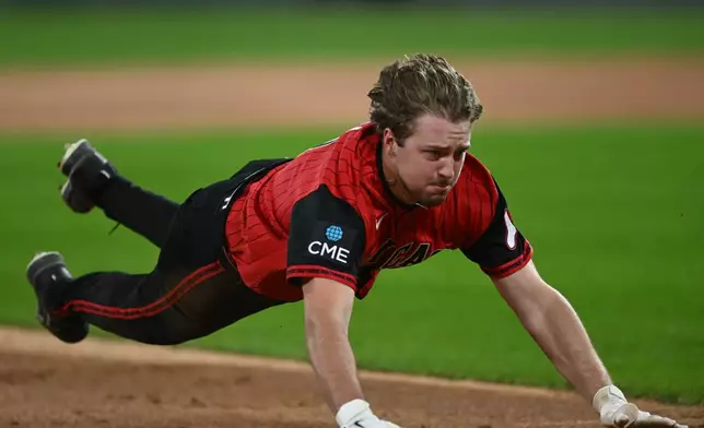 Chicago White Sox's Kyle Teel dives safely into third base during the first inning of a baseball game against the Colorado Rockies, Friday, Sept. 25, 2026, in Chicago. (AP Photo/Paul Beaty)