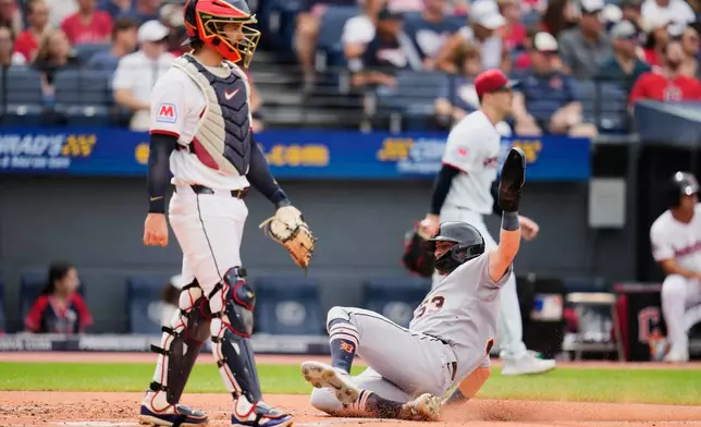 Detroit Tigers' Ben Malgeri, right, slides safely home next to Cleveland Guardians catcher Patrick Bailey, left, in the first inning of the first baseball game of a split doubleheader in Cleveland, Friday, Sept. 4, 2026. (AP Photo/Sue Ogrocki)