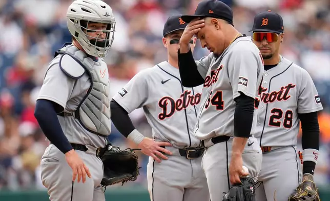 Detroit Tigers pitcher Keider Montero (54) wipes his face as catcher Dillon Dingler, left, looks on during a mound meeting in the fourth inning of the first baseball game of a split doubleheader against the Cleveland Guardians in Cleveland, Friday, Sept. 4, 2026. (AP Photo/Sue Ogrocki)