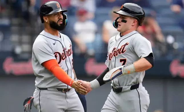 Detroit Tigers' Kevin McGonigle (7) is greeted by Gleyber Torres, left, after scoring in the first inning of the first baseball game of a split doubleheader in Cleveland, Friday, Sept. 4, 2026. (AP Photo/Sue Ogrocki)
