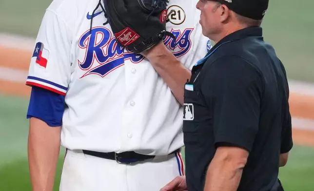 Texas Rangers pitcher Jacob deGrom talks to home plate umpire Tripp Gibson during the fifth inning of a baseball game against the Boston Red Sox, Tuesday, Sept. 15, 2026, in Arlington, Texas. (AP Photo/Julio Cortez)