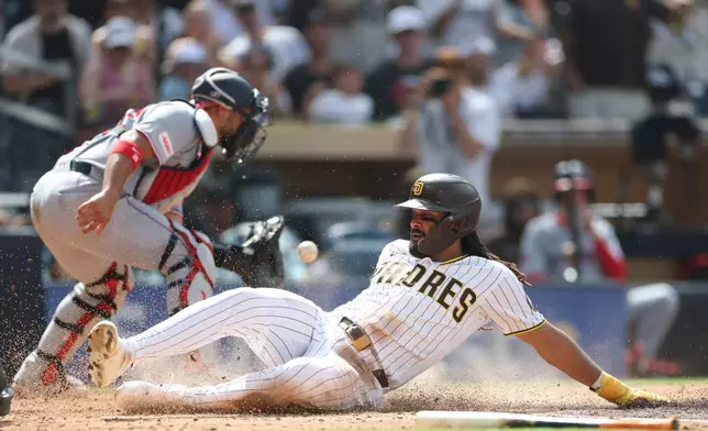 San Diego Padres' Fernando Tatis Jr., right, scores on Manny Machado's RBI single in the third inning of a baseball game against the Washington Nationals, Monday, Sept. 7, 2026, in San Diego. (AP Photo/Karl Anderson)