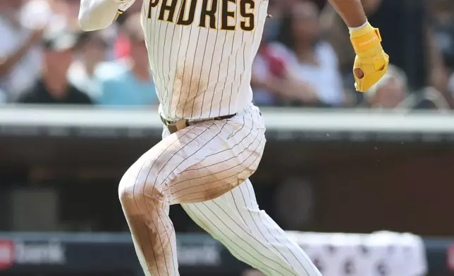 San Diego Padres' Fernando Tatis Jr. runs home to score on Manny Machado's RBI single in the third inning of a baseball game against the Washington Nationals, Monday, Sept. 7, 2026, in San Diego. (AP Photo/Karl Anderson)