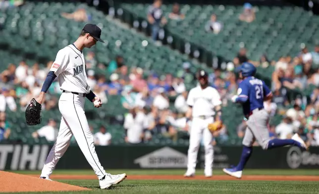 Seattle Mariners starting pitcher Kade Anderson, left, looks on as Texas Rangers Jake Burger (21) rounds the bases after hitting a home run during the second inning of a baseball game, Wednesday, Sept. 9, 2026, in Seattle. (AP Photo/Jason Redmond)