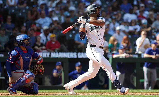 Seattle Mariners Lazaro Montes follows through on a double as Texas Rangers catcher Elias Díaz looks on during the seventh inning of a baseball game, Wednesday, Sept. 9, 2026, in Seattle. (AP Photo/Jason Redmond)