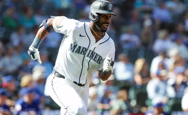 Seattle Mariners Lazaro Montes takes off from home after hitting a double off Texas Rangers relief pitcher Trevor Williams during the seventh inning of a baseball game, Wednesday, Sept. 9, 2026, in Seattle. (AP Photo/Jason Redmond)