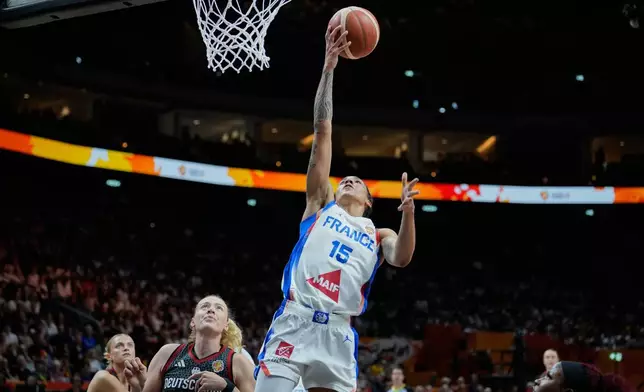 France's Gabby Williams scores over Germany's Marie Guelich during the Women's Basketball World Cup semifinal match between France and Germany in Berlin, Saturday, Sept. 12, 2026. (AP Photo/Ebrahim Noroozi)