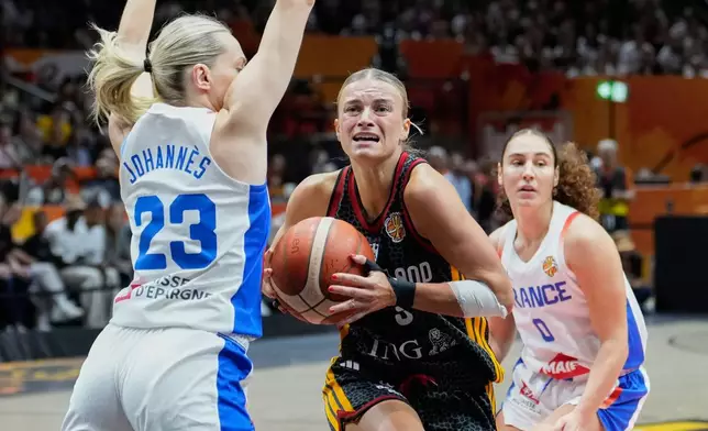France's Marine Johannes guards Germany's Alexandra Wilke during the Women's Basketball World Cup semifinal match between France and Germany in Berlin, Saturday, Sept. 12, 2026. (AP Photo/Ebrahim Noroozi)