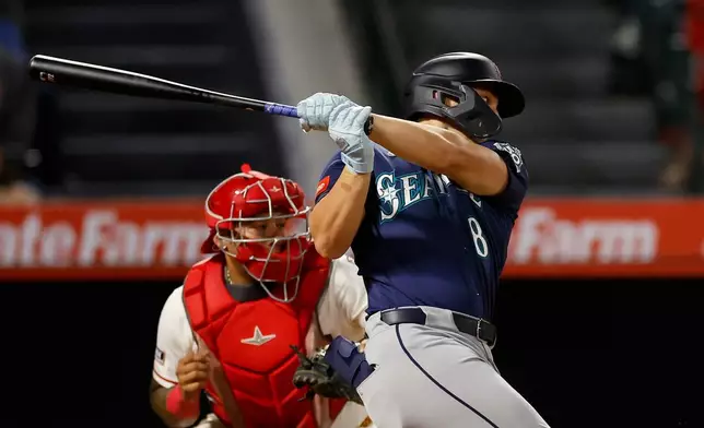 Seattle Mariners designated hitter Dominic Canzone (8) hits an RBI single during the sixth inning of a baseball game against the Los Angeles Angels, Wednesday, Sept. 16, 2026, in Anaheim, Calif. (AP Photo/Caroline Brehman)