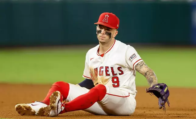 Los Angeles Angels shortstop Zach Neto (9) reacts after a ground ball gets past him during the fifth inning of a baseball game against the Seattle Mariners, Wednesday, Sept. 16, 2026, in Anaheim, Calif. (AP Photo/Caroline Brehman)