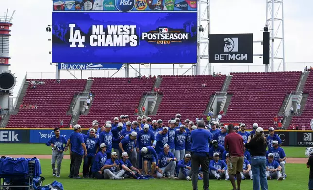 The Los Angeles Dodgers pose for a team photo after they clinched the playoffs after a win against the Cincinnati Reds during a baseball game on Thursday, Sept. 17, 2026 in Cincinnati. (AP Photo/Tanner Pearson)