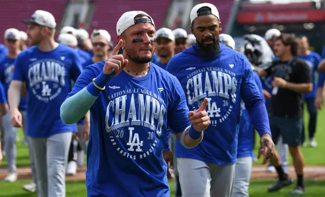 Los Angeles Dodgers second baseman Miguel Rojas (72) walks back to the dugout after the team clinched their fifth consecutive NL West division title after a baseball game against the Cincinnati Reds, Thursday, Sept. 17, 2026 in Cincinnati. (AP Photo/Tanner Pearson)
