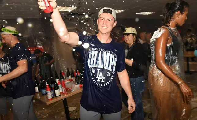 Los Angeles Dodgers catcher Will Smith celebrates in the locker room after the Dodgers clinch the playoffs during a baseball game against the Cincinnati Reds on Thursday, Sept. 17, 2026 in Cincinnati. (AP Photo/Tanner Pearson)