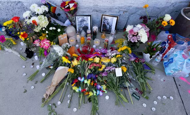 A growing memorial sits outside the Venture-N Bar in Tucson, Ariz., Tuesday, Sept. 1, 2026, for Vincent Siquieros and Cameron Capara, pictured, who were fatally shot in the parking lot of the gay bar shortly after midnight Monday. (AP Photo/Rebecca Noble)
