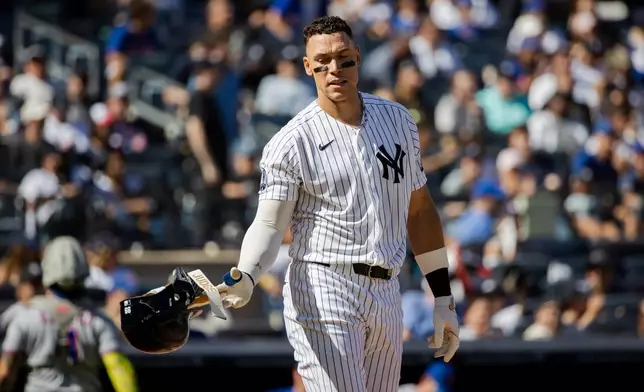 New York Yankees' Aaron Judge removes his batting helmet after striking out during the third inning of a baseball game against the New York Mets, Sunday, Sept. 13, 2026, in New York. (AP Photo/Angelina Katsanis)
