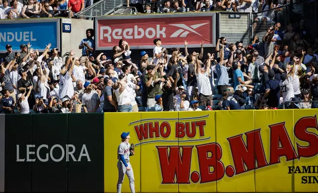 The crowd watches a hit by New York Yankees Austin Wells become a home run during the third inning of a baseball game against the New York Mets, Sunday, Sept. 13, 2026, in New York. (AP Photo/Angelina Katsanis)