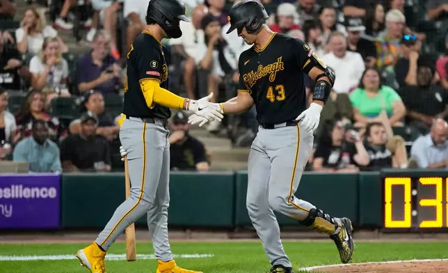 Pittsburgh Pirates' Rafael Flores Jr., right, celebrates with Jacob Gonzalez after hitting a solo home run during the fifth inning of a baseball game against the Chicago White Sox in Chicago, Tuesday, Sept. 8, 2026. (AP Photo/Nam Y. Huh)