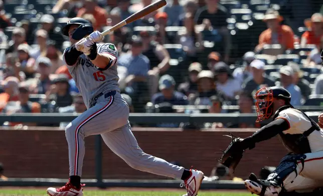 Minnesota Twins' Luke Keaschall (15) watches a solo home run in front of San Francisco Giants catcher Andrew Knizner, right, during the third inning of a baseball game in San Francisco, Wednesday, Sept. 23, 2026. (AP Photo/Jed Jacobsohn)