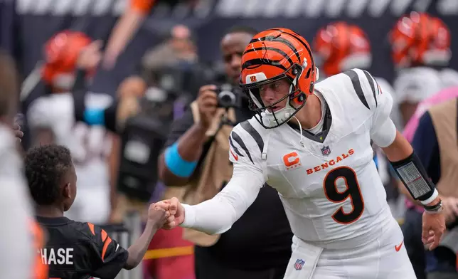 Cincinnati Bengals quarterback Joe Burrow greets fans before an NFL football game against the Houston Texans in Houston, Sunday, Sept. 20, 2026. (AP Photo/David J. Phillip)