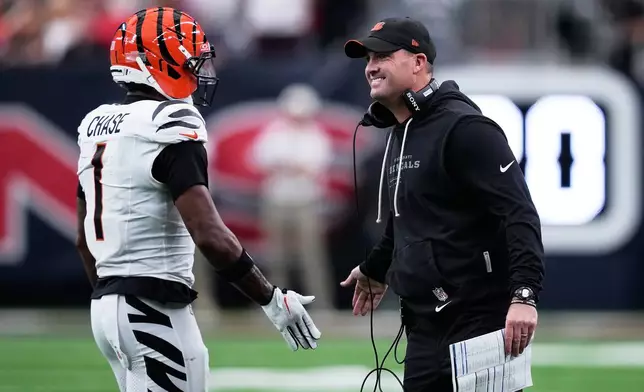 Cincinnati Bengals wide receiver Ja'marr Chase (1) celebrates with Cincinnati Bengals head coach Zac Taylor, right, after scoring a touchdown during the first half of an NFL football game against the Houston Texans in Houston, Sunday, Sept. 20, 2026. (AP Photo/David J. Phillip)