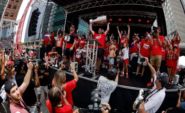 FILE - Carolina Hurricanes lead the crowd in a final storm surge with Jordan Staal (11) holding the Stanley Cup during Stanley Cup Celebration in Raleigh, N.C., June 20, 2026. (AP Photo/Karl DeBlaker, File)