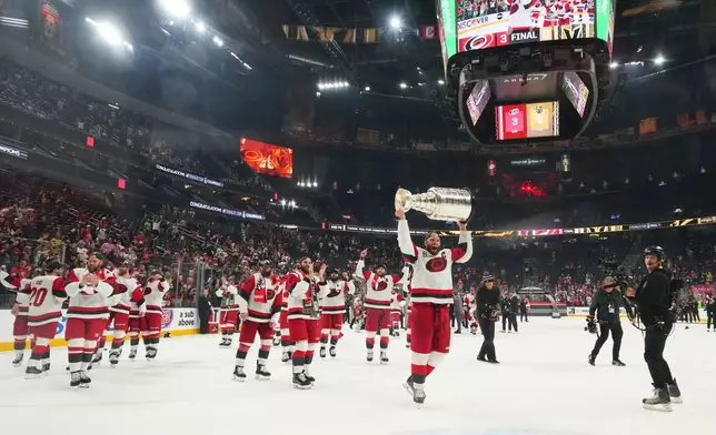 FILE - Carolina Hurricanes center Jordan Staal (11) lifts the Stanley Cup after a win over the Vegas Golden Knights in Game 6 of the NHL hockey Stanley Cup Final series, June 14, 2026, in Las Vegas. (AP Photo/Candice Ward, File)