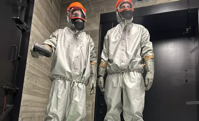 Finnish conscripts measure radiation levels at a shelter in Kuopio, Finland, during a civil defense exercise Wednesday, Sept. 2, 2026. (AP Photo/Emma Burrows)