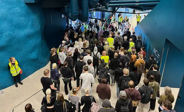 People enter a shelter designed to withstand chemical, nuclear and biological attacks during at civil defense exercise in Kuopio, Finland, Wednesday, Sept. 2, 2026. (AP Photo/Emma Burrows)