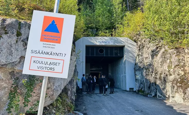 People stand at an entrance of a shelter designed to withstand chemical, nuclear and biological attacks during at civil defense exercise in Kuopio, Finland, Wednesday, Sept. 2, 2026. (AP Photo/Emma Burrows)