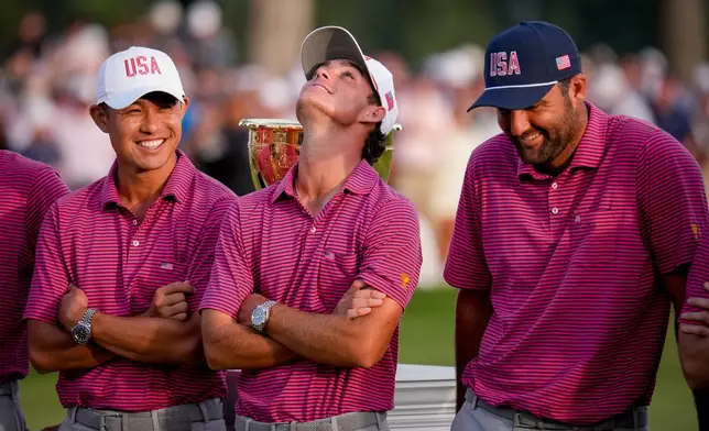 USA teams' Jackson Koivun, center, Collin Morikawa, left, and Scottie Scheffler celebrate after their win over the International team in the Presidents Cup golf tournament final round at Medinah Country Club, Sunday, Sept. 27, 2026, in Medinah, Ill. (AP Photo/Matt Slocum)