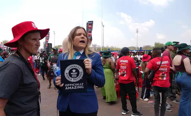 Guinness World Records adjudicator Paulina Sapinska, right, monitors an attempt to break a world record for the most people cooking simultaneously at a barbecue at Loftus Versfeld Stadium, Pretoria, South Africa, Thursday, Sept. 24, 2026. (AP Photo/Alfonso Nqunjana)