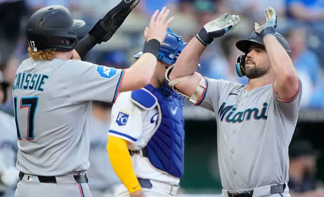 Miami Marlins' Graham Pauley celebrates with Owen Caissie after hitting a two-run home run during the second inning of a baseball game against the Kansas City Royals, Tuesday, Sept. 1, 2026, in Kansas City, Mo. (AP Photo/Charlie Riedel)